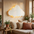 Glowing cloud wall light above a cozy linen reading nook