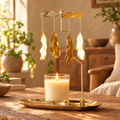 Gold spinning candle carousel with a lit candle on a rustic wooden table