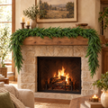 Norfolk Pine Garland draped across a rustic fireplace mantel