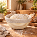Rattan sourdough banneton with linen liner and rising dough on a kitchen counter