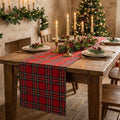 Red tartan table runner on a farmhouse table set for Christmas